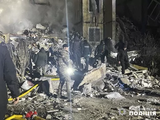 In this photo provided by the Ukrainian Police Press Office, emergency workers work on the site of a destroyed multi-store building after a Russian attack on residential neighbourhood in Odesa, Ukraine, Saturday, March 2, 2024. (Ukrainian Police Press Office via AP)