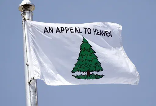 Mississippi National Day of Prayer attendees raise a “Appeal to Heaven” flag in lieu of the Mississippi State flag at the Mississippi State Capitol in Jackson, Miss., Thursday, May 3, 2018. Voters in Maine are going to decide in November 2024, whether to adopt a new flag, but the state needs to settle on a design first. The process was without controversy until publicity surrounding a similar-looking flag flown at the vacation home of Supreme Court Justice Samuel Alito. (AP Photo/Rogelio V. 
