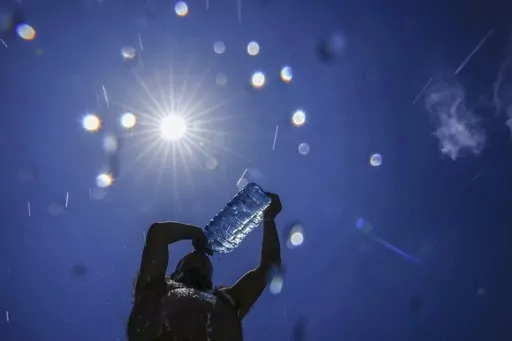 A man pours cold water onto his head to cool off on a sweltering hot day in the Mediterranean Sea in Beirut, Lebanon, July 16, 2023. European climate monitoring organization made it official: July 2023 was Earth's hottest month on record by a wide margin. (AP Photo/Hassan Ammar, File)