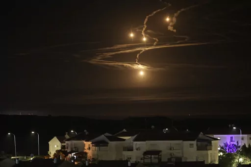 Flares rise over the Gaza Strip as seen from southern Israel, Monday, Jan. 8, 2024. (AP Photo/Leo Correa)