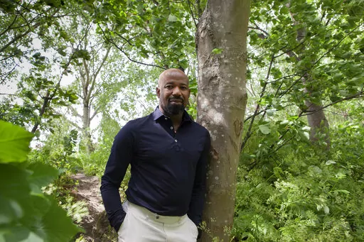 Peris Conrad of the Dutch police poses for a picture in Rotterdam, Netherlands, Thursday, May 26, 2022. Conrad features in a new documentary about discrimination within the ranks of the Netherlands police which has sparked a national conversation about racism, with many officers and others hoping this will finally bring about the change they have long been fighting for. "De Blauwe Familie", or "The Blue Family", discusses a culture of bullying and fear in the national police force. (AP Photo/Jan