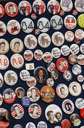 This photo shows buttons from the 1984 Reagan-Bush campaign. Reagan announced on Jan. 29, 1984. His approval rating was 52% that month. Despite concerns about his age — he was 73 and the oldest president in history at the time — Reagan handily defeated Walter Mondale, a Democrat. (AP Photo, File)