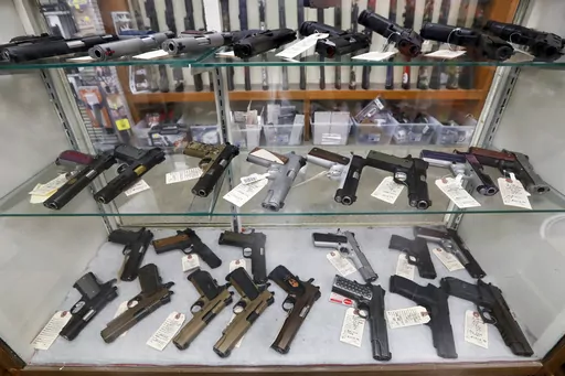 Semi-automatic handguns are displayed at shop in New Castle, Pa., March 25, 2020. A federal appeals court has dealt a legal setback to the Biden administration on guns in a lawsuit challenging tighter regulations on stabilizing braces, an accessory used in several mass shootings. The Fifth Circuit Court of Appeals temporarily blocked an administration rule from going into effect for the gun owners and groups who filed the lawsuit. The order came shortly before a deadline for people to register t