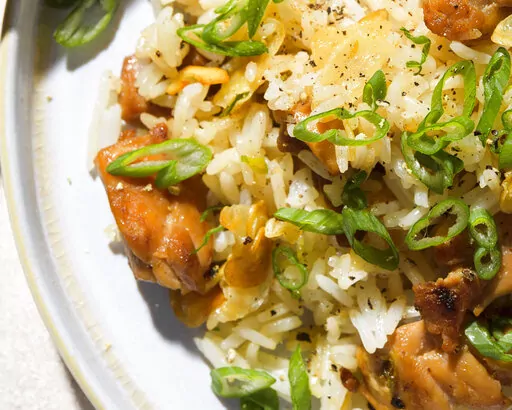 This image released by Milk Street shows a recipe for Garlic Fried Rice w/Chicken. (Milk Street via AP)