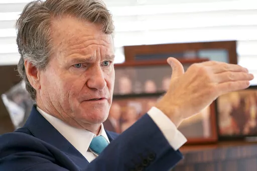 Brian Moynihan, CEO of Bank of America, is photographed during an interview at the Bank of America Tower, Wednesday, Aug. 17, 2022, in the Manhattan borough of New York.  Bank of America says the revenue it gets from overdrafts has dropped 90% from a year ago, after the bank reduced overdraft fees to $10 from $35 and eliminated fees for bounced checks.   (AP Photo/John Minchillo)