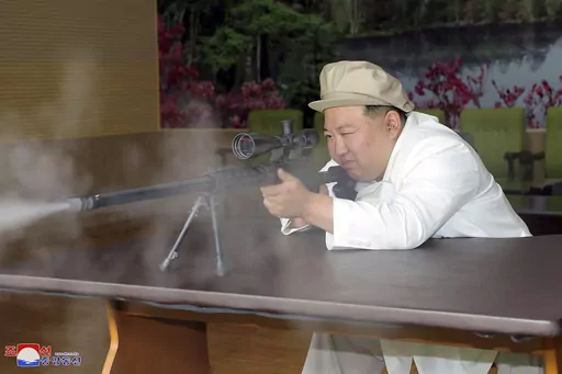 In this undated photo provided by the North Korean government, North Korean leader Kim Jong Un tries a weapon during his three-day inspection from Aug. 3 until Aug. 5, 2023 at major munitions factories in North Korea. Independent journalists were not given access to cover the event depicted in this image distributed by the North Korean government. The content of this image is as provided and cannot be independently verified. Korean language watermark on image as provided by source reads: "KCNA" 