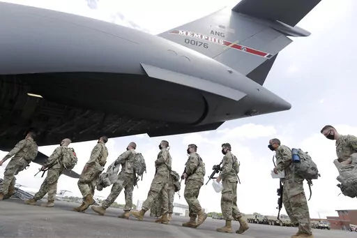 Tennessee National Guard troops board a plane in Smyrna, Tenn., to go to Washington, Thursday, June 4, 2020.  Three current and former members of the Tennessee National Guard are “safe” and “accounted for,” despite a Russian newspaper’s false report, Thursday, March, 17, 2022, that the men were killed while fighting in Ukraine.  All three individuals named in the report, are alive and well — and no U.S. military personnel are currently on orders in Ukraine, National Guard Bureau spok