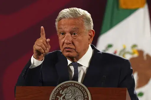 Mexico's President Andres Manuel Lopez Obrador speaks during his daily press conference at the National Palace, in Mexico City, Wednesday, June 22, 2022. Lopez Obrador appealed to the country’s citizens Tuesday, Dec. 27, not to accept holiday handouts and gifts from drug gangs, after videos posted online showed garish pickup trucks handing out loads of gifts while bystanders described the drivers as members of the Jalisco drug cartel. (AP Photo/Marco Ugarte, File)