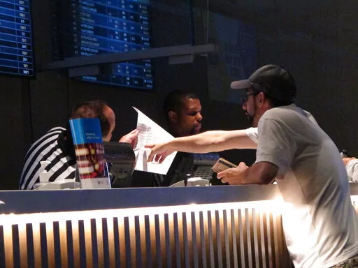 A gambler makes a sports bet at Bally's casino in Atlantic City N.J., Sept. 5, 2019. A record 31.5 million Americans plan to bet on this year's Super Bowl, according to the gambling industry's national trade group. The American Gaming Association on Tuesday, Feb. 8, 2022, released its annual predictions for wagering on pro football's championship game, forecasting that over $7.6 billion will be bet legally and otherwise. (AP Photo/Wayne Parry, File)