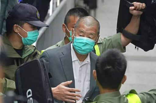 Democracy advocate Jimmy Lai, center, leaves the Hong Kong's Court of Final Appeal in Hong Kong on Feb. 9, 2021. Lai was sentenced to five years and nine months in prison over two fraud charges linked to lease violations in Hong Kong on Saturday, Dec. 10, 2022 the latest of a series of cases against prominent activists that critics say are aimed at snuffing out dissidents in the city. (AP Photo/Kin Cheung, File)