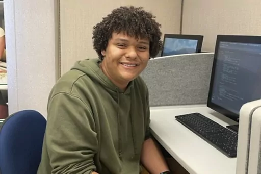 In the photo provided by Jaden Todd, Northern Virginia Community College student Jaden Todd, 21, sits a computer terminal on campus, Thursday, Nov 9, 2023, in Annandale, VA. Todd has plans to transfer to George Mason University to finish a degree in computer science. (Jaden Todd via AP)