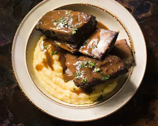This image released by Milk Street shows a recipe for barolo-braised short ribs. (Milk Street via AP)