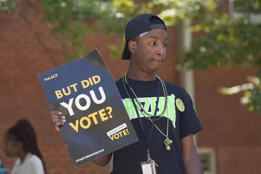 A Jackson State University student holds a sign stressing the importance of voting during a JSU Votes Civic Engagement Initiative on National Voter Registration Day, Sept. 19, 2023, on the Jackson, Miss., campus. According to information from the Mississippi Secretary of State's Office, the number of registered voters in the state has remained steady during the months leading to the Nov. 7 election for governor and other offices. (AP Photo/Rogelio V. Solis, File)