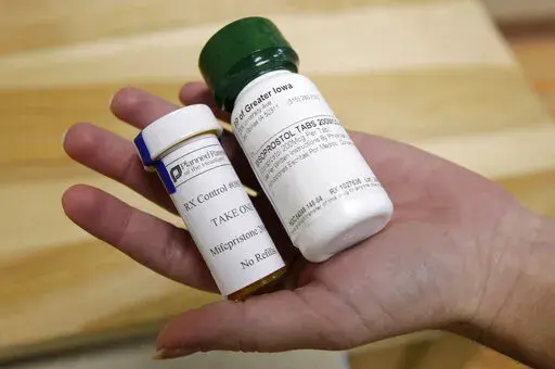 This Sept. 22, 2010 file photo shows bottles of abortion pills at a clinic in Des Moines, Iowa. The Food and Drug Administration on Thursday, Dec. 16, 2021 loosened some restrictions on the pill mifepristone, allowing it to be dispensed by more pharmacies. (AP Photo/Charlie Neibergall, file)