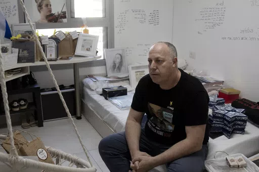 Shlomi Berger sits in his daughter's bedroom in Holon, Israel, Wednesday, April 17, 2024. Agam, 19, was abducted two days after the start of her army service along the border with Gaza during a cross-border attack by Hamas on Oct. 7, 2023. "The Passover story says we come from slaves to free people, so this is a parallel story," Berger said. "This is the only thing I believe that will happen. That Agam will get out from darkness to light. She and all of the other hostages." (AP Photo/Maya Alleru