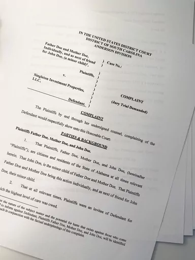 A lawsuit is seen on Thursday, July 27, 2023, in Atlanta. The parents of a teenager with special needs say he was repeatedly sexually assaulted and raped by an employee at the small private boarding school in South Carolina. They have sued the school's parent company, which has denied the allegations. (AP Photo/Brynn Anderson)