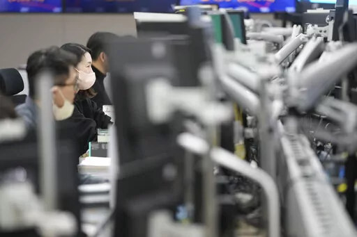 Currency traders watch computer monitors at a foreign exchange dealing room in Seoul, South Korea, Wednesday, Feb. 1, 2023. Asian stock markets were higher Wednesday after Wall Street rose ahead of what traders hope will be the last Federal Reserve interest rate hike for some time. (AP Photo/Lee Jin-man)