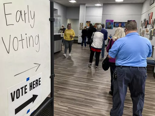 People wait in line to early vote for the U.S. Senate runoff election in Georgia between Sen. Raphael Warnock and challenger Herschel Walker, on Nov. 28, 2022, in Kennesaw, Ga., near Atlanta. After years of criticizing mail voting and trying to ban so-called "ballot harvesting," Republicans are reversing course. They are poised to launch aggressive get-out-the-vote campaigns for 2024 that employ just those strategies.(AP Photo/Mike Stewart, File)