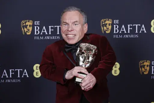 Warwick Davis poses with the BAFTA fellowship award at the 78th British Academy Film Awards, BAFTA's, in London, Sunday, Feb. 16, 2025. (Photo by Joel C Ryan/Invision/AP)