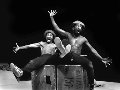FILE — Performers Percy Mtwa, left, and Mbongeni Ngema in a scene from "Woza Albert" at the Market Theatre in Johannesburg, South Africa, in 1981. Ngema, enowned South African playwright, producer and composer has died in a fatal car crash at the age of 68, his family confirmed on Wednesday, Dec. 27, 2023. (AP Photo/Ruphin Coudyzer/File)