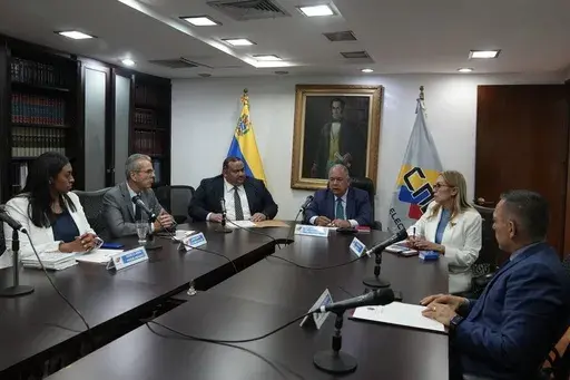 Officials from the National Electoral Council (CNE), from left, Acme Nogal, Juan Delpino, Antonio Meneces, Elvis Hidrobo Amoroso, Rosalba Gil, and Carlos Quintero, hold a private meeting at the CNE headquarters in Caracas, Venezuela, Aug. 25, 2023. (AP Photo/Ariana Cubillos, File)
