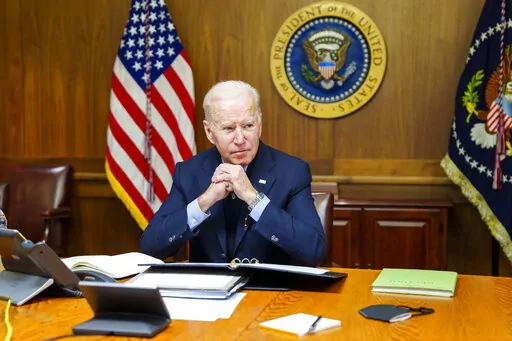 FILE = This image provided by The White House via Twitter shows President Joe Biden at Camp David, Md., Feb. 12, 2022. A new poll finds little support among Americans for a major U.S. role in the Russia-Ukraine conflict. President Joe Biden has acknowledged the growing likelihood of a new war in Eastern Europe will affect Americans even if U.S. troops don’t deploy to Ukraine. Just 26% of Americans say the U.S. should have a major role in the conflict between Russia and Ukraine, according to a 