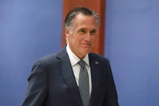 Sen. Mitt Romney, R-Utah, arrives to watch a speech by Ukrainian President Volodymyr Zelenskyy live-streamed into the U.S. Capitol, in Washington, March 16, 2022. Lawmakers seemed on the brink of clinching a bipartisan compromise Thursday, March 31, to provide a fresh $10 billion to combat COVID-19. Romney said bargainers had reach an agreement in principle on a package but said it was still being drafted. Other senators were less definitive but none contested that a deal was near. (AP Photo/Ale