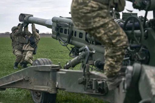 Ukrainian soldiers prepare a U.S.-supplied M777 howitzer to fire at Russian positions in Kherson region, Ukraine, Jan. 9, 2023. A rapidly expanding group of U.S. and allied troops and contractors are using phones and tablets to communicate in encrypted chat rooms to provide real-time maintenance advice to Ukrainian troops on the battlefield. As the U.S. and other allies provide a growing number of increasingly complex and high-tech weapons, the maintenance demands are expanding. (AP Photo/Libkos