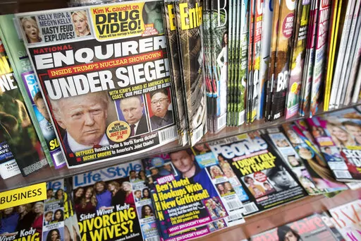 In this July 12, 2017 file photo, an issue of the National Enquirer featuring President Donald Trump on its cover is displayed on a newsstand in a store in New York. VVIP Ventures is buying the U.S. and U.K editions of the National Enquirer, the tabloid that engaged in “catch-and-kill” practices to bury stories about Donald Trump during his presidential campaign. Financial terms were not disclosed. (AP Photo/Mary Altaffer, File)