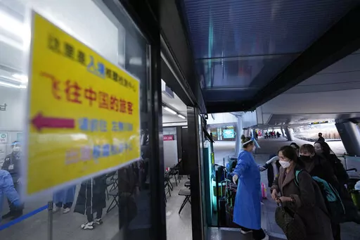 Passengers arriving from China enters a COVID-19 testing center at the Incheon International Airport in Incheon, South Korea, Tuesday, Jan. 10, 2023. China suspended visas Tuesday for South Koreans to come to the country for tourism or business in apparent retaliation for COVID-19 testing requirements on Chinese travelers. (AP Photo/Ahn Young-joon)