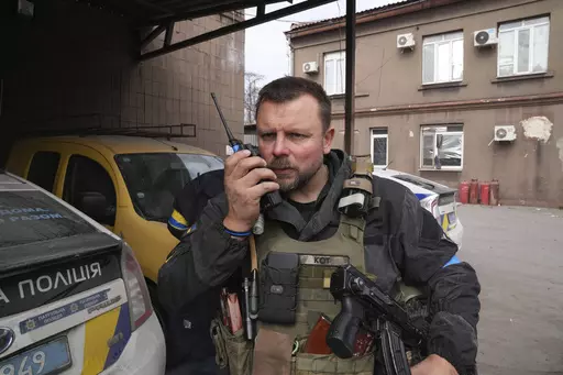 Mikhailo Vershinin, head of Mariupol's Police Patrol speaks by a radio on his base in Mariupol, Ukraine, Tuesday, March 15, 2022. The Mariupol police officer who was among the last defenders to surrender from the Azovstal steel mill is among those to mark a year since they surrendered on orders of the Ukrainian president. The group are treated as heroes across Ukraine for drawing Russian forces away from the attack elsewhere in the country and for changing the course of the war. (AP Photo/Evgeni