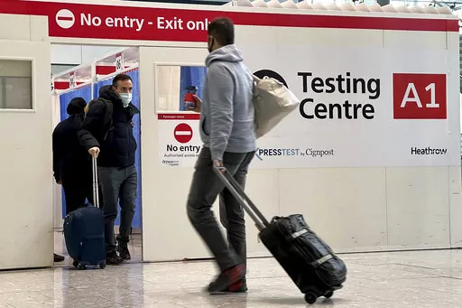 Passengers get a COVID-19 test at Heathrow Airport in London, Nov. 29, 2021.  The Biden administration is lifting its requirement that international air travelers to the U.S. take a COVID-19 test within a day before boarding their flights, easing one of the last remaining government mandates meant to contain the spread of the coronavirus. A senior administration official says the mandate expires Sunday at 12:01 a.m. Eastern time. The official says the Centers for Disease Control and Prevention h