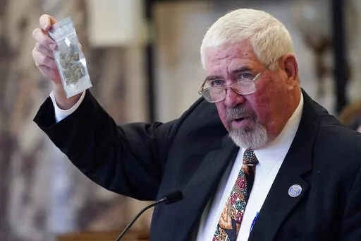 State Sen. Kevin Blackwell, R-Southaven, lead negotiator, holds a bag of hemp to illustrate to lawmakers what specific portions of the Mississippi Medical Cannabis Equivalency Units would look like during his presentation of the Mississippi Medical Cannabis Act in the Senate Chamber at the Mississippi State Capitol in Jackson, Miss., Thursday, Jan. 13, 2022. The body passed the act. (AP Photo/Rogelio V. Solis)