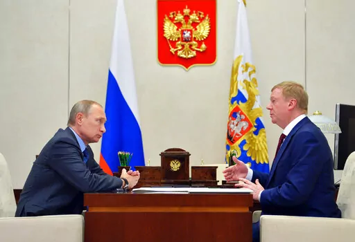 Russian President Vladimir Putin, left, listens to RUSNANO CEO Anatoly Chubais in the Novo-Ogaryovo residence, outside Moscow, Russia, Monday, Nov. 7, 2016. The resignation of Chubais, who was Putin's envoy to international organizations for sustainable development, was not the first resignation of a state official over the war with Ukraine, but it was one of the most striking. (AP Photo)