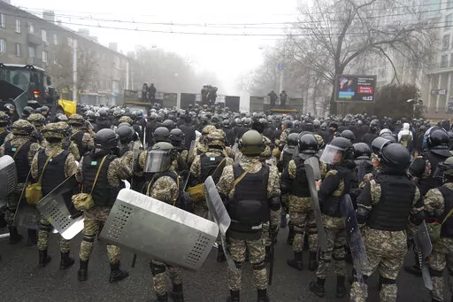 Riot police block a street to prevent demonstrators during a protest in Almaty, Kazakhstan, Wednesday, Jan. 5, 2022. Demonstrators denouncing the doubling of prices for liquefied gas have clashed with police in Kazakhstan's largest city and held protests in about a dozen other cities in the country. (AP Photo/Vladimir Tretyakov)