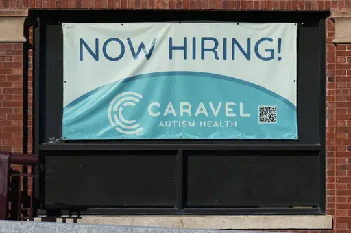 Hiring sign is displayed at a health service center in Chicago, Tuesday, Jan. 21, 2025. (AP Photo/Nam Y. Huh)