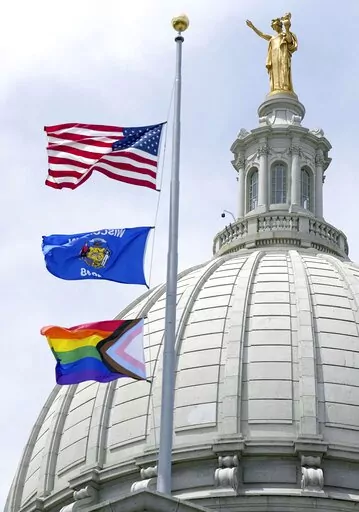 In this Wednesday, June 1, 2022, photo, a Rainbow Pride flag is raised at the Capitol in Madison, Wis. A Wisconsin school board has voted in favor of a policy that prohibits teachers and staff from displaying gay pride flags and other items that district officials consider political in nature. (Mark Hoffman/Milwaukee Journal-Sentinel via AP, File)