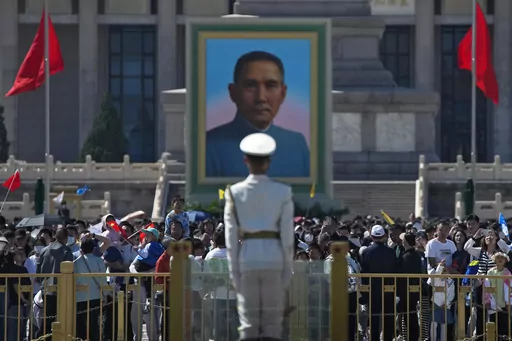 Visitors gather near a portrait of Sun Yat-sen, who is widely regarded as the founding father of modern China, at Tiananmen Square during the May Day holiday period in Beijing, Sunday, April 30, 2023. (AP Photo/Andy Wong)