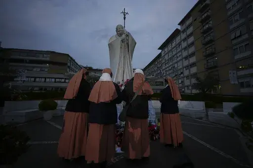 Nuns pray for Pope Francis in front of the Agostino Gemelli Polyclinic, in Rome, Saturday, March 8, 2025, where the Pontiff is hospitalized since Friday, Feb. 14. (AP Photo/Andrew Medichini)