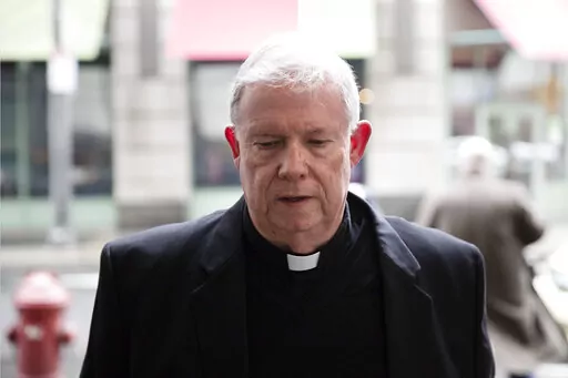 FILE – Monsignor William Lynn arrives for a preliminary hearing in his retrial of his child endangerment case at the Center for Criminal Justice in Philadelphia, March 28, 2017. Lynn, the longtime secretary for clergy, was accused of sending a known predator, named on a list of problem priests he had prepared for Cardinal Bevilacqua, to an accuser’s northeast Philadelphia parish. Lynn served nearly three years in state prison before appeals courts threw out his felony child endangerment conv