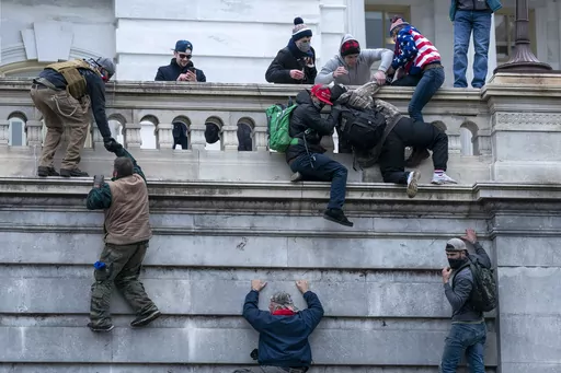 Rioters loyal to President Donald Trump climb the west wall of the the U.S. Capitol, Jan. 6, 2021, in Washington. (AP Photo/Jose Luis Magana, File)