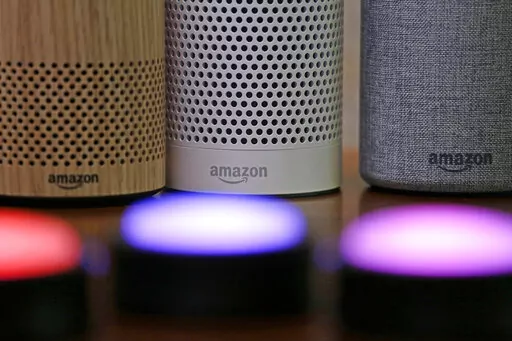 Amazon Echo and Echo Plus devices, behind, sit near illuminated Echo Button devices during an event by the company in Seattle on Sept. 27, 2017. Amazon’s Alexa might soon replicate the voice of family members - even if they’re dead. The capability, unveiled at Amazon’s Re:Mars conference in Las Vegas Wednesday, June 22, 2022, is in development and would allow the virtual assistant to mimic the voice of a specific person based on a less than a minute of provided recording. (AP Photo/Elaine 
