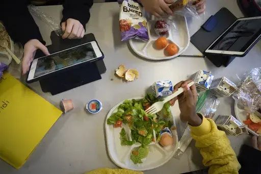 Seventh graders sit together in the cafeteria during their lunch break at a public school, Friday, Feb. 10, 2023, in the Brooklyn borough of New York. (AP Photo/Wong Maye-E, File)