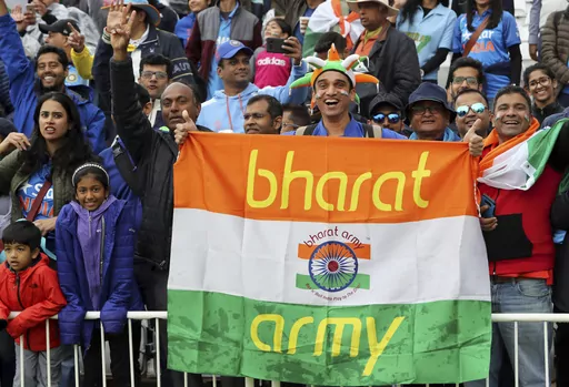 FILE- Indian cricket fans wait for the start of the Cricket World Cup match between India and New Zealand at Trent Bridge in Nottingham, Thursday, June 13, 2019. India has two official names: India, a nomenclature used and accepted in English communication worldwide, and a Sanskrit and Hindi appellation that is “Bharat.” This choice of name is now under spotlight, with Prime Minister Narendra Modi’s government making calls that Indians should rather call their country Bharat and not India.