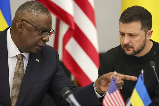 U.S. Secretary of Defense Lloyd Austin, left, speaks with Ukraine's President Volodymyr Zelenskyy during the Ukraine Defense Contact Group meeting of NATO defense ministers at NATO headquarters in Brussels, Oct. 11, 2023. Ukraine has used U.S weapons to attack inside Russia in recent days. That's according to a Western official familiar with the matter. The weapons were used under recently approved guidance from President Joe Biden allowing American arms to be used to strike inside Russia for th