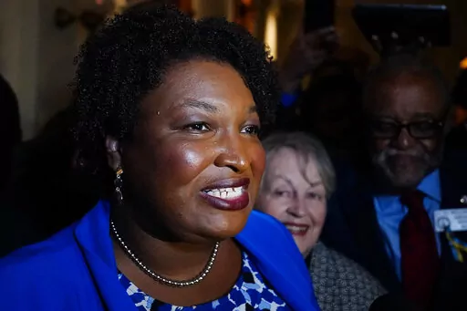 Georgia gubernatorial Democratic candidate Stacey Abrams talks to the media after qualifying for the 2022 election on Tuesday, March 8, 2022, in Atlanta.  Abrams has become a millionaire. A disclosure filed in March shows the candidate for governor is worth $3.17 million, thanks mostly to book and speaking income. Abrams was worth $109,000 in 2018 when she first ran for governor. (AP Photo/Brynn Anderson, File)