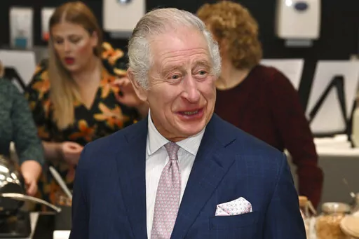 Britain's King Charles III visits the kitchen inside the headquarters of cereal manufacturer Kellogg's marking its 100th anniversary in Manchester, England, Friday Jan. 20, 2023. (Paul Ellis/Pool via AP)