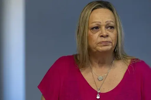 Lori Ellinger becomes emotional while talking about the death of her son, Trea Ellinger, Monday, July 1, 2024, at her home in Glen Burnie, Md. (AP Photo/Stephanie Scarbrough)