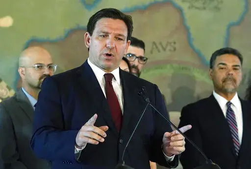 Florida Gov. Ron DeSantis speaks at Miami's Freedom Tower, on May 9, 2022. The Special Olympics has dropped a coronavirus vaccine mandate for its games in Orlando after Florida moved to fine the organization $27.5 million for violating a state law against such rules.  DeSantis, on Friday, June 3, 2022,  announced that the organization had removed the requirement for its competition in the state, which is scheduled to run June 5 to June 12. (AP Photo/Marta Lavandier, File)