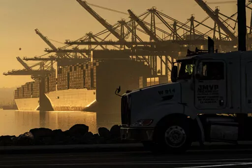A truck arrives to pick up a shipping container near vessels at the Port of Los Angeles, on Nov. 30, 2021. An influential government advisory panel comprised of major U.S. businesses is proposing new rules that would roll back already limited public access to import data, a move that trade experts say would make it harder to trace labor abuse by foreign suppliers. The proposal, if adopted, would shroud in secrecy customs data on ocean-going freight responsible for about half of the $2.7 trillion